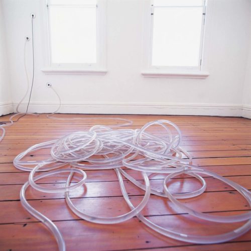 transparent water hose on wooden floor