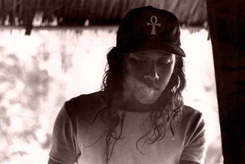 Javanese young man exhaling smoke